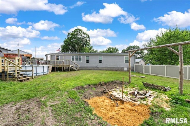 524 6th St, Andover, IL 61233 - back of property featuring a wooden deck, stairs, and a garden