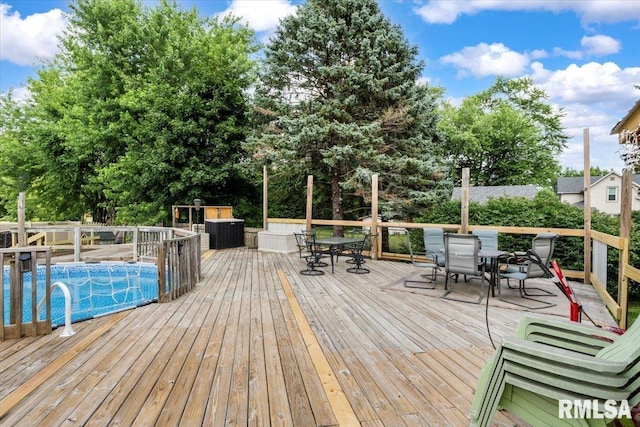 524 6th St, Andover, IL 61233 - deck with outdoor dining area, an outdoor pool, and view of scattered trees