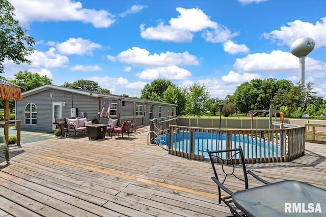 524 6th St, Andover, IL 61233 - wooden terrace featuring an outdoor pool and an outdoor living space