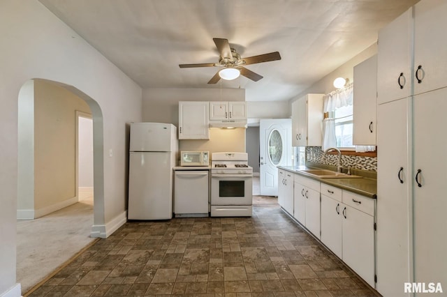 2511 N 4th St, Clinton, IA 52732 - kitchen featuring white appliances, under cabinet range hood, ceiling fan, white cabinets, and stone finish floors