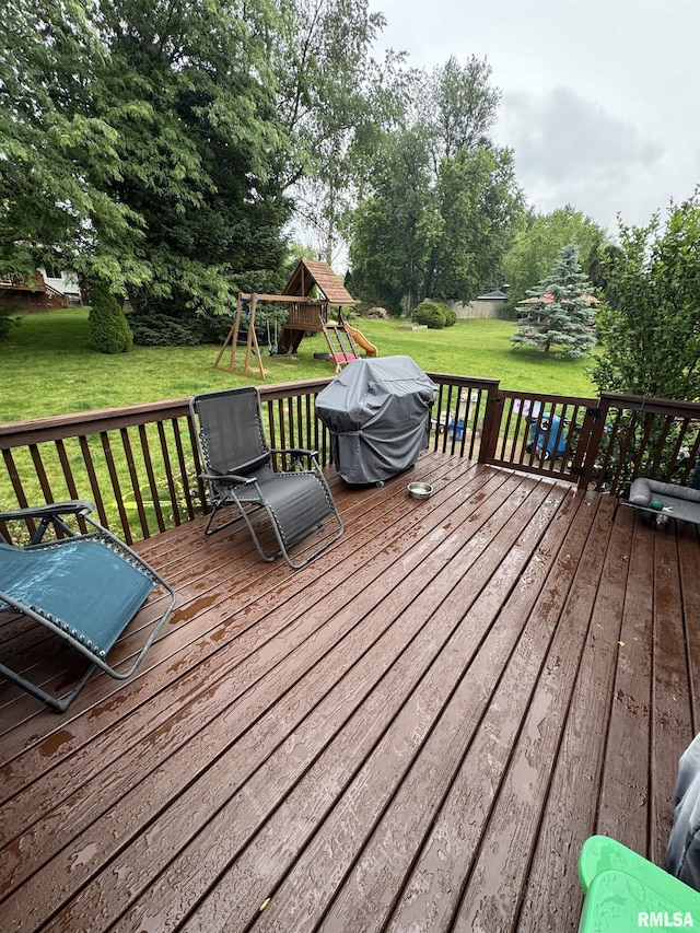 310 Westminster Rd, Germantown Hills, IL 61548 - deck featuring a playground, a grill, a yard, and view of wooded area