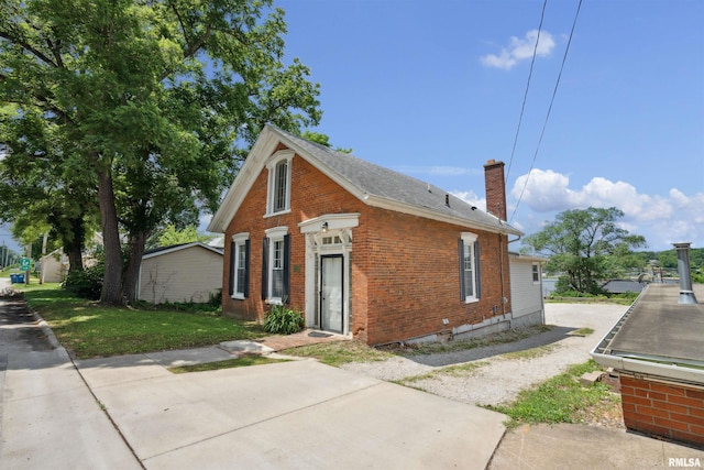 107 S High St, Port Byron, IL 61275 - view of front facade with brick siding, a chimney, and roof with shingles