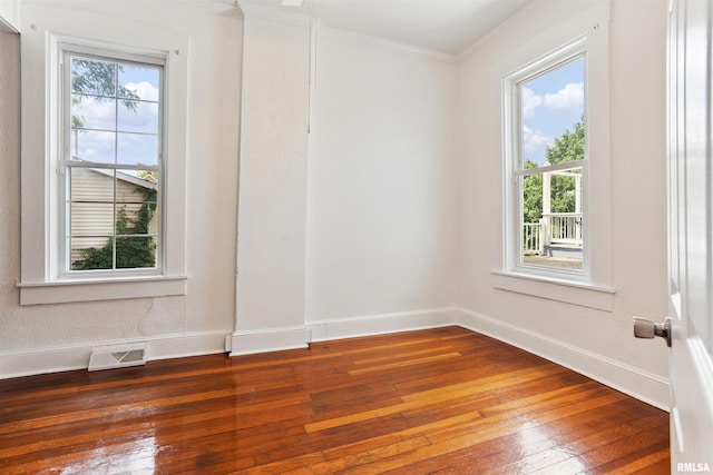 107 S High St, Port Byron, IL 61275 - empty room featuring hardwood / wood-style flooring, plenty of natural light, and ornamental molding