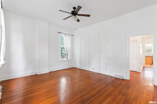 107 S High St, Port Byron, IL 61275 - unfurnished room featuring hardwood / wood-style flooring, healthy amount of natural light, and ceiling fan