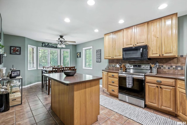 885 47th Ave, East Moline, IL 61244 - kitchen featuring electric range, black microwave, dark countertops, backsplash, and a center island