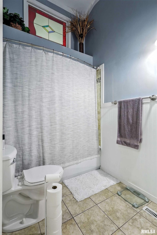 885 47th Ave, East Moline, IL 61244 - full bathroom with tile patterned floors, curtained shower, and wainscoting