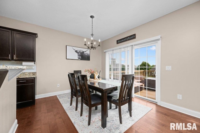 67 Cobblestone Ln, Le Claire, IA 52753 - dining space featuring a chandelier and dark wood-type flooring