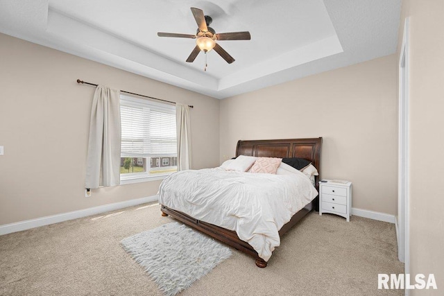 67 Cobblestone Ln, Le Claire, IA 52753 - bedroom featuring light colored carpet, a tray ceiling, and ceiling fan