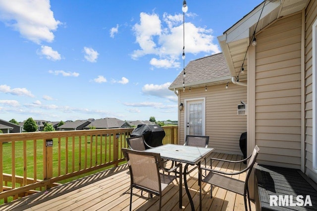 67 Cobblestone Ln, Le Claire, IA 52753 - wooden deck featuring area for grilling, a yard, outdoor dining space, and a residential view