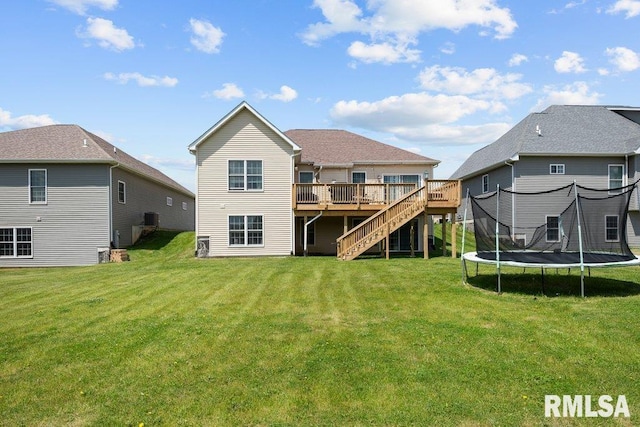 67 Cobblestone Ln, Le Claire, IA 52753 - rear view of house with a trampoline, stairs, a deck, and a lawn