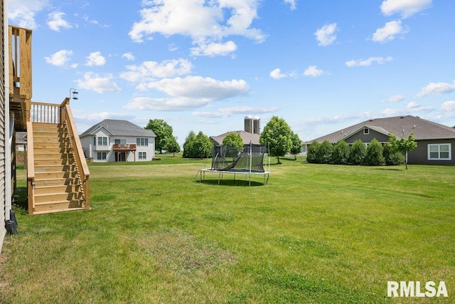 67 Cobblestone Ln, Le Claire, IA 52753 - view of grassy yard featuring a trampoline and stairway