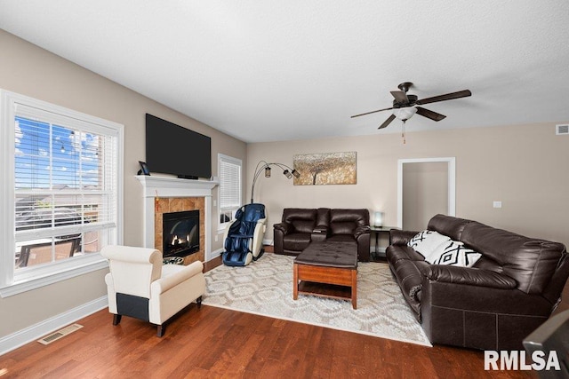 67 Cobblestone Ln, Le Claire, IA 52753 - living area featuring a ceiling fan, wood finished floors, and a tiled fireplace