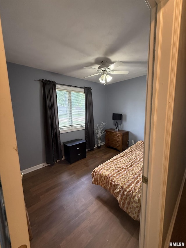 172 E Meadow Ln, Walcott, IA 52773 - bedroom with dark wood finished floors and a ceiling fan