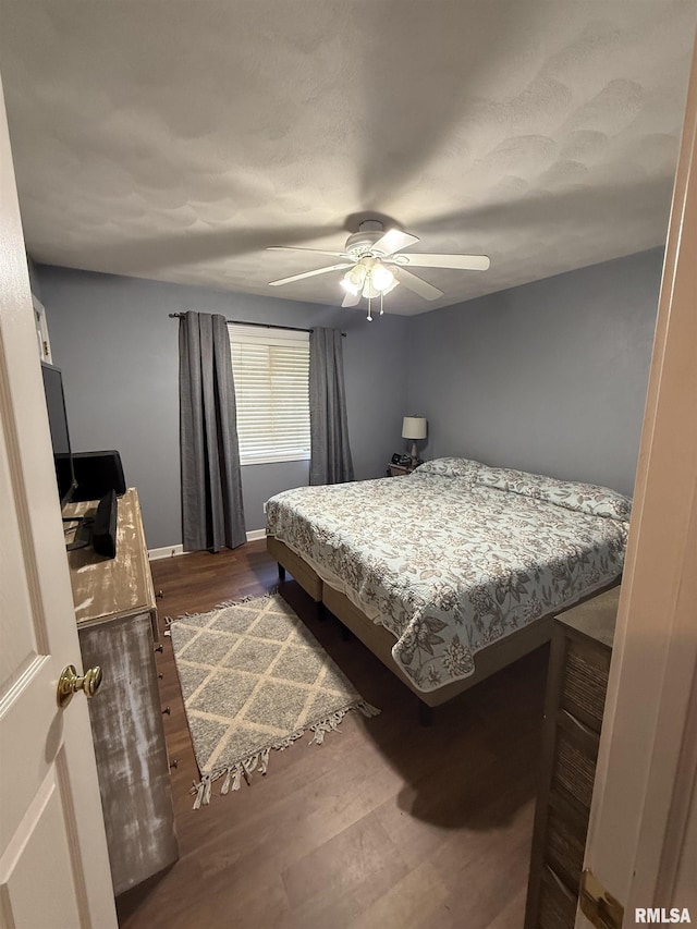 172 E Meadow Ln, Walcott, IA 52773 - bedroom with dark wood-type flooring and a ceiling fan