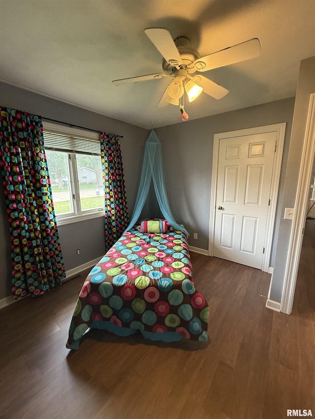 172 E Meadow Ln, Walcott, IA 52773 - bedroom featuring dark wood-style flooring and a ceiling fan