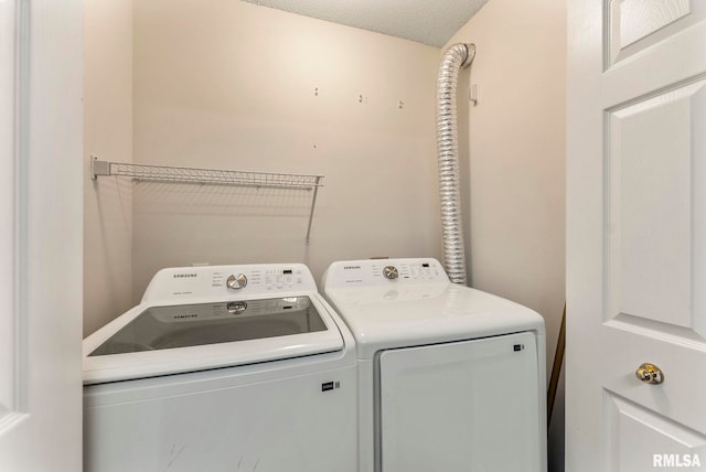 3215 S 16th Ave Unit 201, Eldridge, IA 52748 - washroom with washer and clothes dryer and a textured ceiling