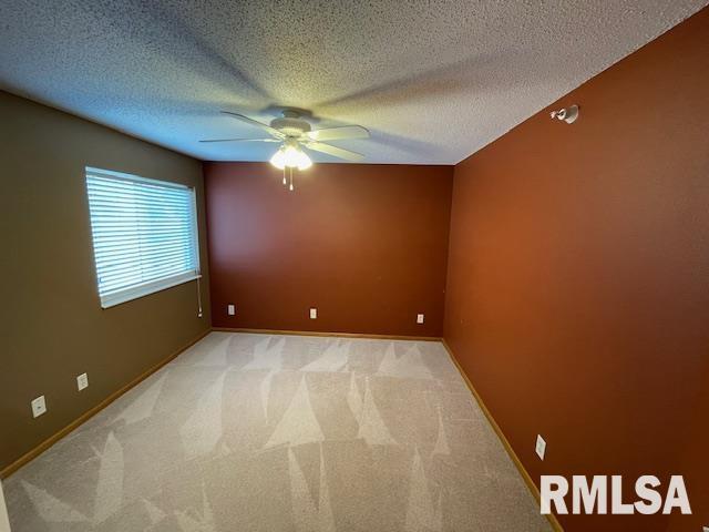 3215 S 16th Ave Unit 201, Eldridge, IA 52748 - empty room with a ceiling fan, light colored carpet, and a textured ceiling