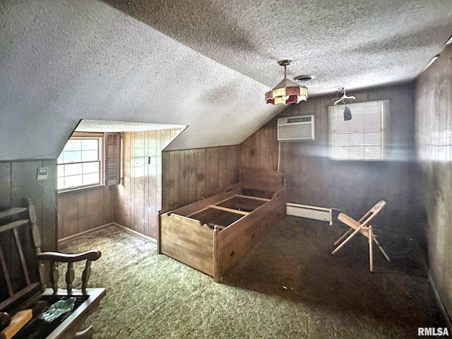 900 E 4th St, West Frankfort, IL 62896 - bonus room featuring carpet flooring, wooden walls, a wall unit AC, a textured ceiling, and a baseboard heating unit