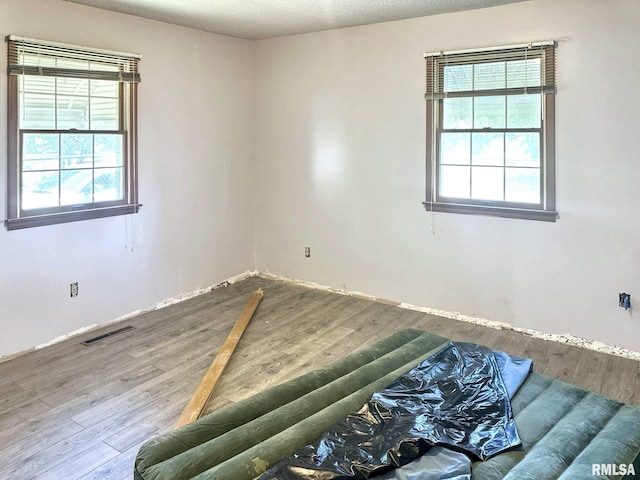 900 E 4th St, West Frankfort, IL 62896 - empty room with wood finished floors and a textured ceiling