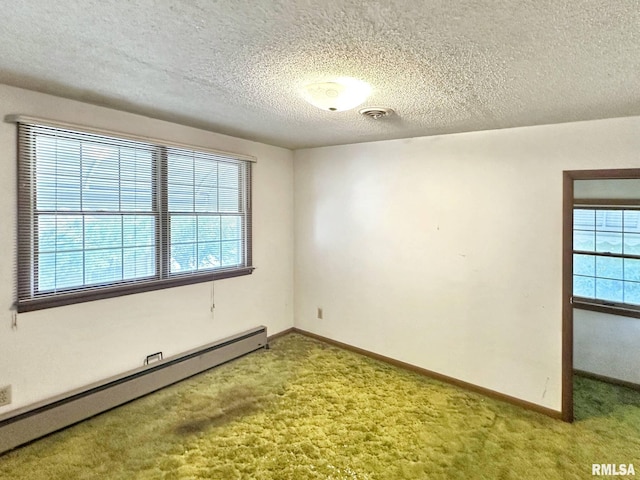 900 E 4th St, West Frankfort, IL 62896 - carpeted empty room featuring baseboard heating and a textured ceiling