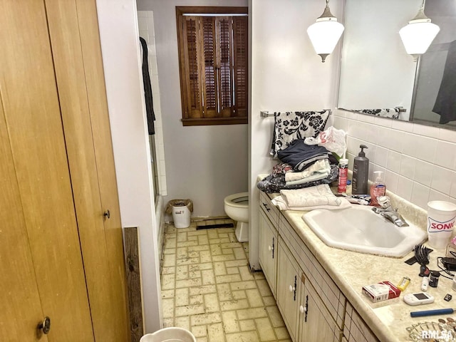 900 E 4th St, West Frankfort, IL 62896 - full bath with brick patterned floors, vanity, tasteful backsplash, and a shower
