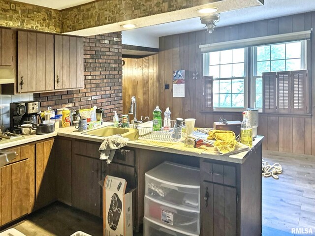 900 E 4th St, West Frankfort, IL 62896 - kitchen featuring wooden walls, light countertops, dark wood finished floors, and a peninsula