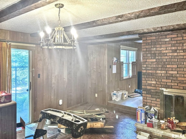 900 E 4th St, West Frankfort, IL 62896 - dining room featuring a textured ceiling, beamed ceiling, a chandelier, and wooden walls