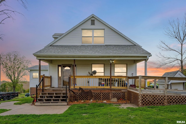 829 Union Ave, Lowden, IA 52255 - view of front of property with roof with shingles, a lawn, and covered porch