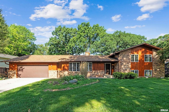 2351 5th St, East Moline, IL 61244 - tri-level home with an attached garage, a front yard, driveway, stone siding, and a chimney