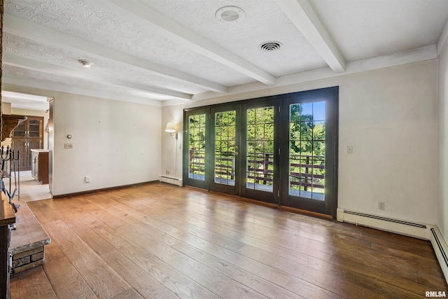 2351 5th St, East Moline, IL 61244 - spare room with a baseboard heating unit, beam ceiling, and hardwood / wood-style floors