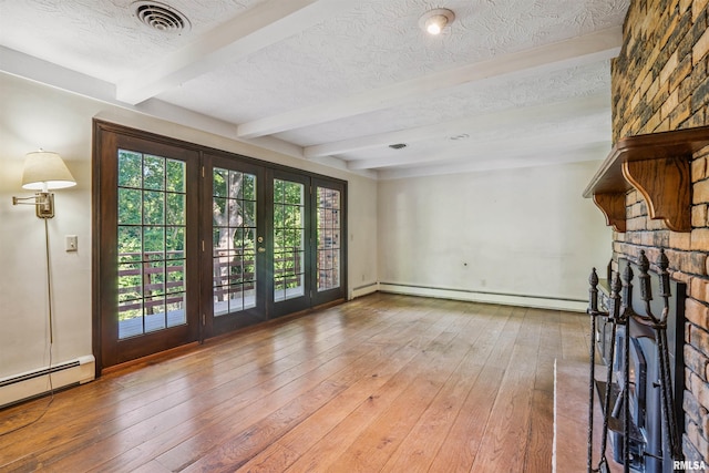 2351 5th St, East Moline, IL 61244 - unfurnished living room featuring beam ceiling, baseboard heating, a baseboard radiator, wood-type flooring, and french doors