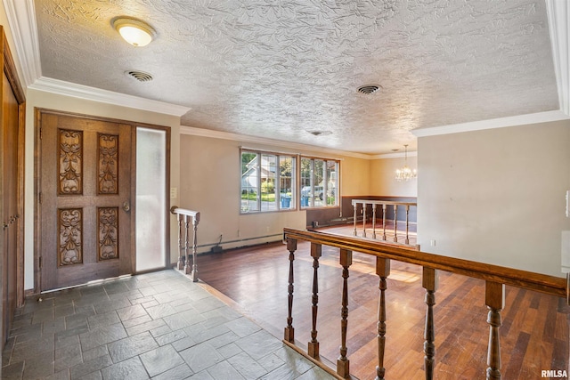 2351 5th St, East Moline, IL 61244 - entryway featuring a chandelier, crown molding, a textured ceiling, baseboard heating, and stone tile floors