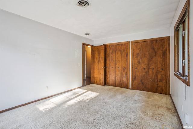 2351 5th St, East Moline, IL 61244 - unfurnished bedroom featuring carpet flooring and two closets