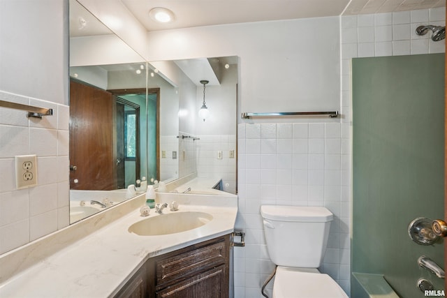 2351 5th St, East Moline, IL 61244 - full bathroom featuring tile walls, vanity, tub / shower combination, and wainscoting
