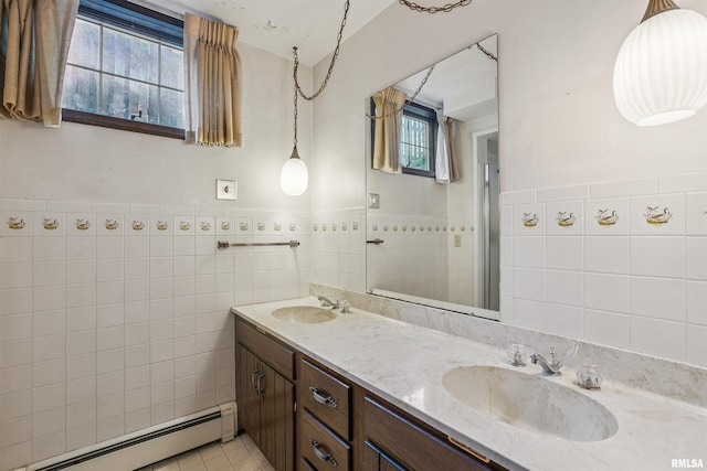 2351 5th St, East Moline, IL 61244 - full bath featuring a baseboard radiator, tile walls, healthy amount of natural light, double vanity, and tile patterned floors