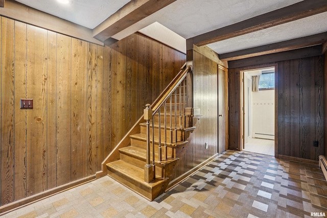 2351 5th St, East Moline, IL 61244 - stairway featuring wooden walls, tile patterned floors, baseboard heating, and beam ceiling