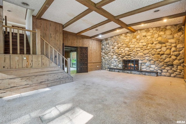 2351 5th St, East Moline, IL 61244 - unfurnished living room with stairway, a fireplace, a textured ceiling, carpet floors, and wood walls