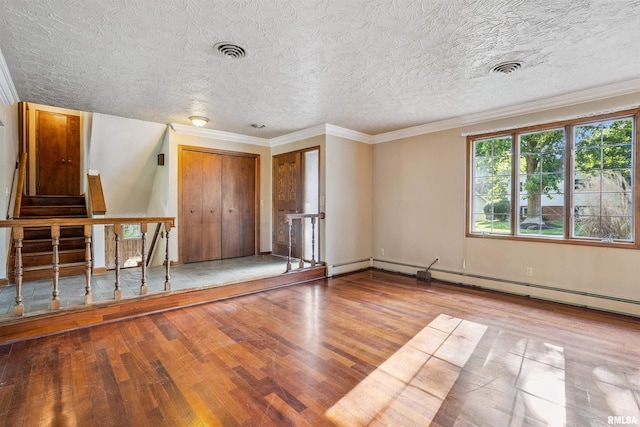 2351 5th St, East Moline, IL 61244 - spare room featuring wood finished floors, a textured ceiling, and ornamental molding