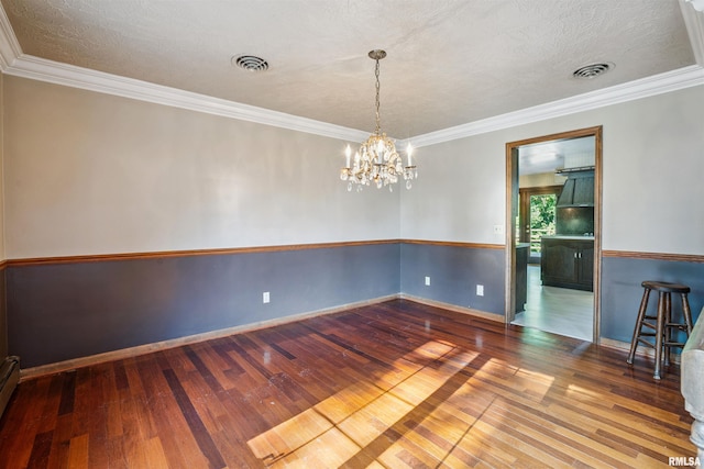 2351 5th St, East Moline, IL 61244 - unfurnished room with hardwood / wood-style flooring, a chandelier, ornamental molding, a baseboard radiator, and a textured ceiling