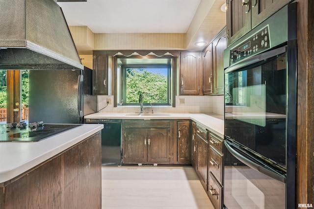 2351 5th St, East Moline, IL 61244 - kitchen featuring black appliances, custom exhaust hood, light countertops, tasteful backsplash, and dark brown cabinets
