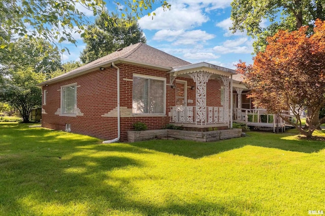 613 S Locust, West Frankfort, IL 62896 - view of front of home featuring brick siding, a porch, a front lawn, and roof with shingles