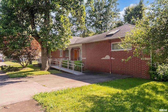 613 S Locust, West Frankfort, IL 62896 - view of front facade with a front yard, brick siding, and roof with shingles