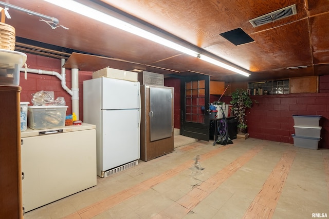 613 S Locust, West Frankfort, IL 62896 - basement featuring freestanding refrigerator, concrete block wall, and tile patterned floors