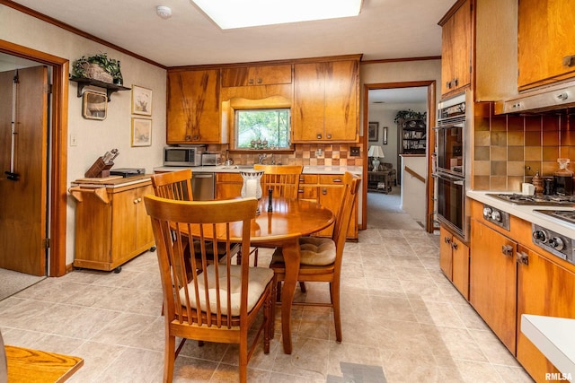 613 S Locust, West Frankfort, IL 62896 - kitchen featuring brown cabinets, light countertops, ornamental molding, and tasteful backsplash