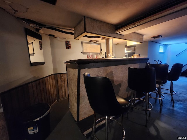 3217 18th Ave, Rock Island, IL 61201 - indoor dry bar with concrete floors, wainscoting, and wooden walls