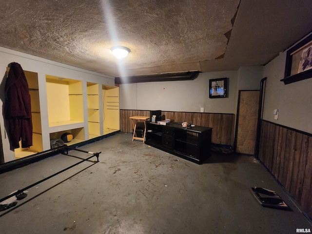 3217 18th Ave, Rock Island, IL 61201 - finished basement with a wainscoted wall, wooden walls, and a textured ceiling