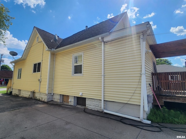 3217 18th Ave, Rock Island, IL 61201 - view of side of property featuring roof with shingles and a patio area