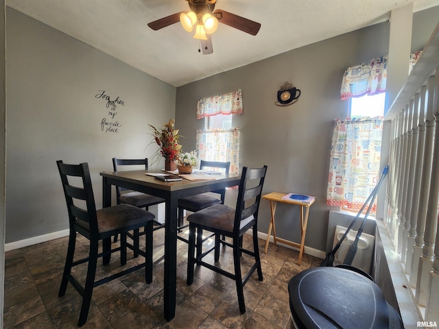 3217 18th Ave, Rock Island, IL 61201 - dining area featuring stone finish flooring and ceiling fan