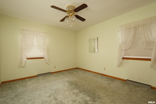 2518 13th St, Rock Island, IL 61201 - unfurnished room with baseboard heating, carpet floors, and a ceiling fan