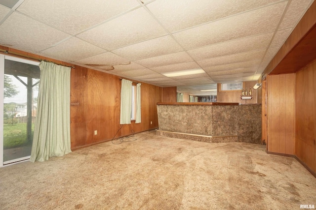 2518 13th St, Rock Island, IL 61201 - basement with wood walls, carpet, and a paneled ceiling
